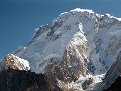 
Just after leaving Concordia, the sun finally hit Broad Peak. The North Summit is on the far left, the Central Summit is slightly out of view in the middle, and on the far right is the Main Summit. The first ascent of Broad Peak North summit was made by Renato Casarotto on June 28, 1983. The first traverse of the three Broad Peak summits was completed by Jerzy Kukuczka and Wojtek Kurtyka. They climbed the west ridge to the North summit, continued along the ridge to the Central summit. The pair then descended to Broad Col from where they followed the original route over the Forepeak to the main summit on July 17, 1984.
The first ascent of the Broad Peak Central or Middle summit was completed by Poles Kazimierz Glazek and Janusz Kulis on July 28, 1975 while three other members huddled 40m away and a few metres lower.
